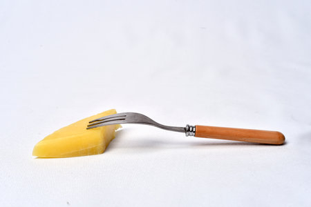 piece of cheeseon the table on white background