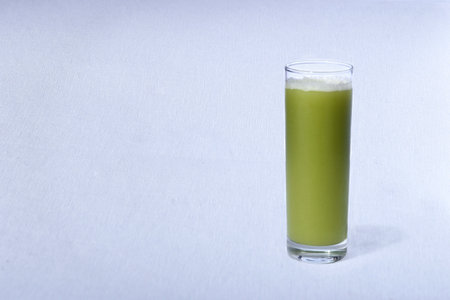 green juice with natural fruits on white background.の写真素材