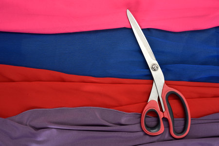 colored fabrics cut with scissors.の写真素材