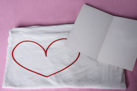 blank message card with heart shirt on pink background