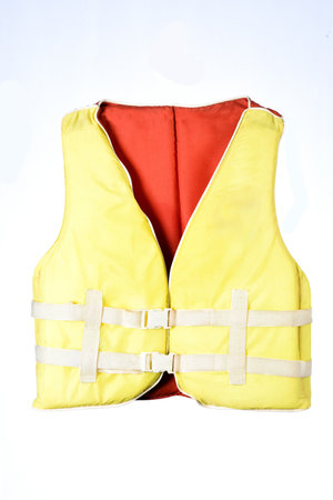 Marine safety equipment, flotation device and water activities concept with a yellow life jacket...