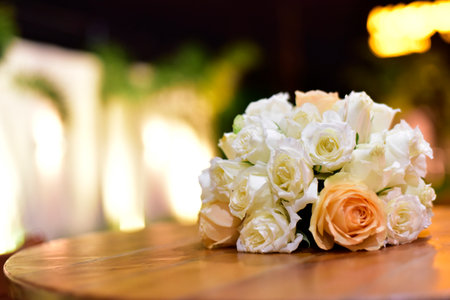 beautiful arrangement of white flowers on wooden table on blurred background;の写真素材