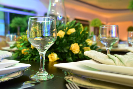 Table setting with glasses, plates, napkins and foodの写真素材