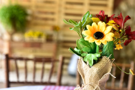 beautiful decorative arrangement of natural flowers on the table on blurred backgroundの写真素材