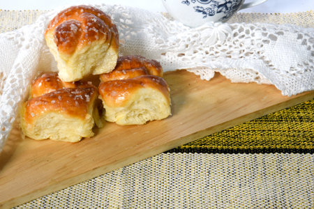 Sweet bread, typical of the Brazilian bakery, on the table on white background with space for text....