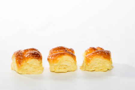 Sweet bread, typical of the Brazilian bakery, on the table on white background with space for text. It has the name of Rosca.の写真素材
