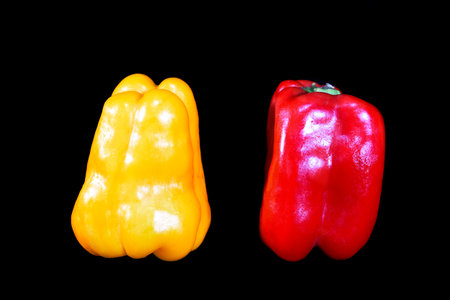 natural yellow and red pepper isolated on black backgroundの写真素材