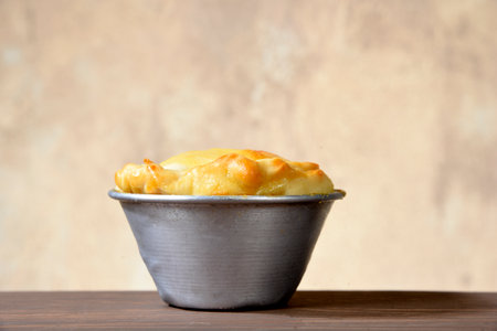 baked pie stuffed with chicken, shrimp, meat on the table, isolated on blurred background. typical Brazilian food empadinhaの写真素材