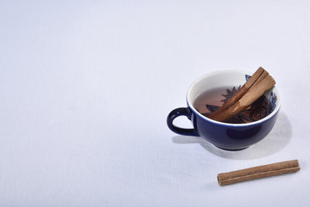 lemon grass green tea in blue cup with cinnamon husks isolated on white background.の写真素材