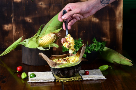 delicious corn pamonha, typical Brazilian food, baked corn cake with seasonings and melted and...