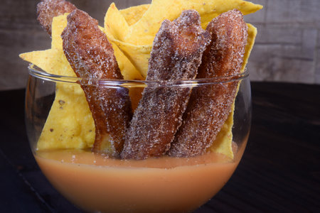 mexican food, churros with condensed milk and nachos tex mex dessert