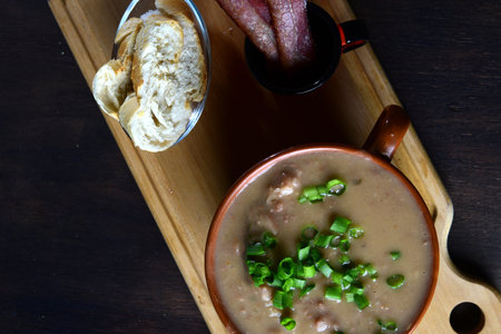Delicious bean broth with bacon, bread and pepper, typical Brazilian food.