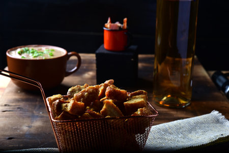delicious fried pork rinds, typical Brazilian food served in a metal basket