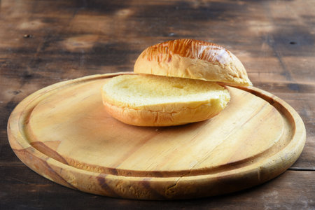 brioche bread, used in sandwich cut on wooden baseの写真素材
