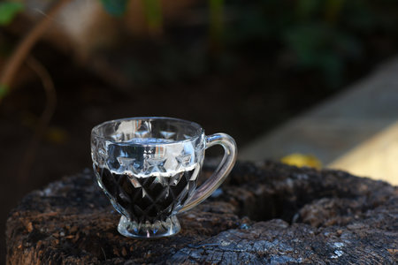 coffee cup on rustic wooden base with blurred background