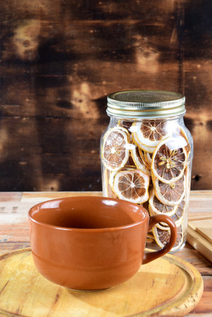 bean broth with chives, bacon and bread, served in an earthenware cup on a wooden baseの写真素材