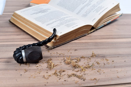 bottle of red wine with pipe and old bookの写真素材