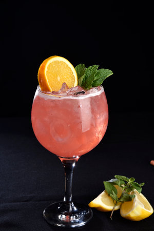 Iced drink with citrus fruits lemon orange alcoholic cocktail martini vodka margerita run tropical fruit juiceの写真素材