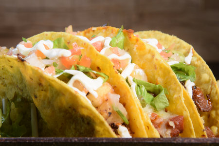 Mexican food tacos, fried chicken, greens, mango, avocado, pepper, red cabbage in tex-mex mix tortillasの写真素材