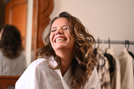 young woman wearing terrycloth feminine bathrobeの写真素材