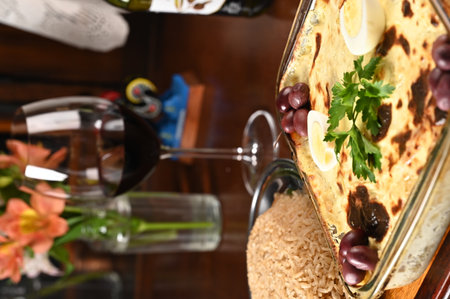 bolognese lasagna baked with cheese ham red sauce spices and meat with french fries and riceの写真素材