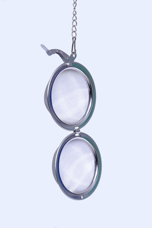 stainless steel tea infuser for hot water metal strainer isolated on white background.