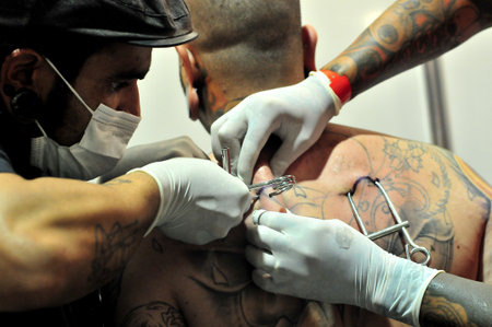 Goiania Skin piercing tattoo convention hanging equipment with metal hook hang bright metal hook on hands surgeon glovesのeditorial素材