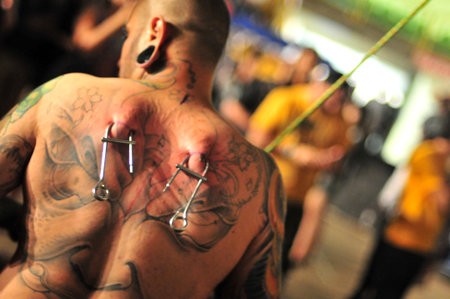 Goiania Skin piercing tattoo convention hanging equipment with metal hook hang bright metal hook on hands surgeon glovesのeditorial素材