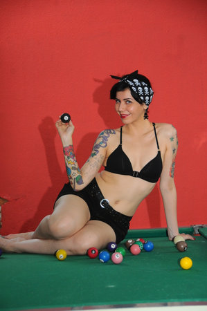 Goiania, Goias, Brazil - April 21, 2012: young relaxed rock style girl having fun playing pool snookerのeditorial素材