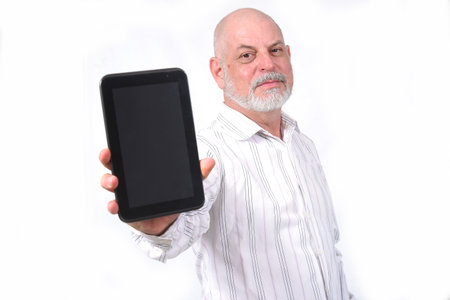 adult man using "SeniorLife" tablet notebook cell phone communication technologyの写真素材