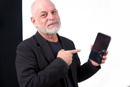 adult man using "SeniorLife" tablet notebook cell phone communication technologyの写真素材