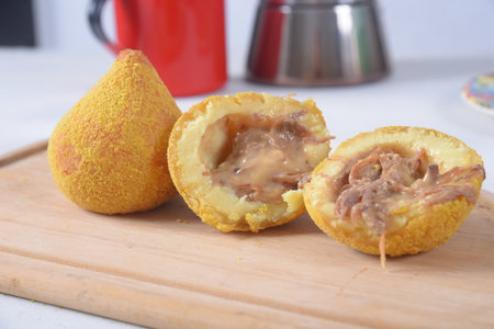 Coxinha traditional brazilian snack Chicken coxinha. potato dumpling stuffed with chicken and dried...