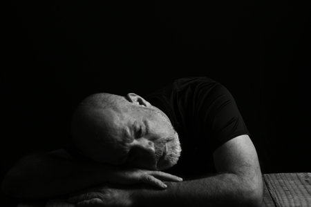man sitting drinking wine face expression black and white photo with silhouette adult drinkの写真素材