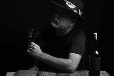 man sitting drinking wine face expression black and white photo with silhouette adult drink