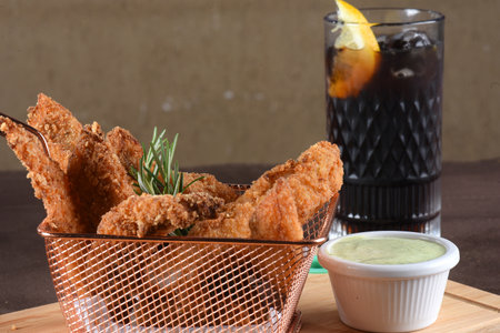 fried fish bait in slices, tasty food breaded codfish with sauceの写真素材