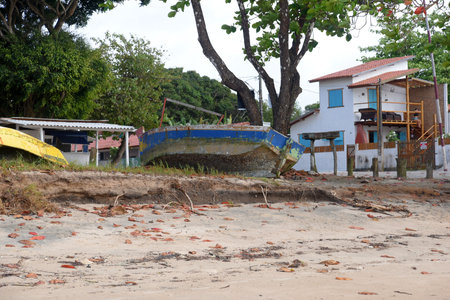 Brazil, Bahia September 7, 2023: old fishermen's boats abandoned on dirty beach trash dirt pollution fishermen beatのeditorial素材