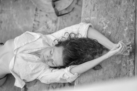 young relaxed woman on the beach model summer coastline light clothing lipstick sunglasses hair and nature lock beltifullの写真素材