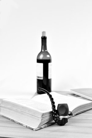 old pipe on the table with book and wine poetic image moment of relaxation imageの写真素材