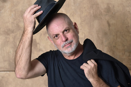 bald adult man white beard face expression male model gentleman in black clothes and hat
