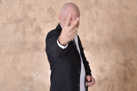 portrait of charming man in black suit white gray beard smiling modelの写真素材