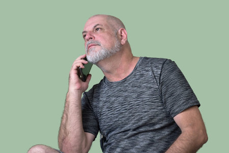 portrait adult man bald white beard face expression happy thoughtful male model gentleman in modern clothes image with cell phone.の写真素材