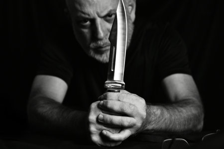 man wielding make expressively holding cutting metal blade black and white photo art expression imageの写真素材