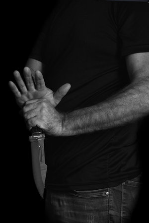 man wielding make expressively holding cutting metal blade black and white photo art expression imageの写真素材