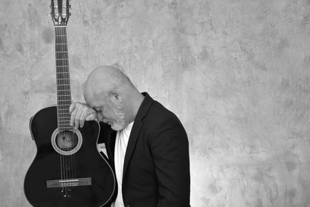 portrait adult man with white beard and bald head happy expression isolated on image model man playing guitar.の写真素材