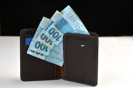 Goiania, Brazil February 24, 2025: dollar and Brazilian real banknotes financial valueの写真素材