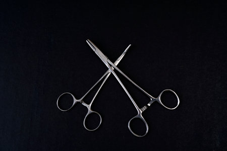 Forceps tool. Stainless steel hemostatic surgical forceps with locking clamps. Curved fishing pliers; straight tip. Medical instruments; supplyの写真素材