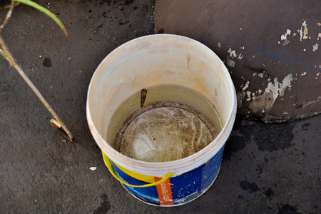 abandoned plastic bowl with stagnant water inside. close up view.