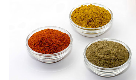 curry pepper and paprika in glass bowls isolatedの写真素材