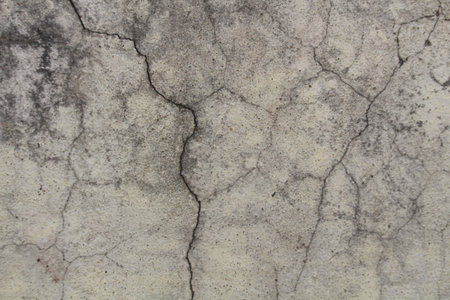 Grungy old white wall with cracks. Real cracks on wallの写真素材