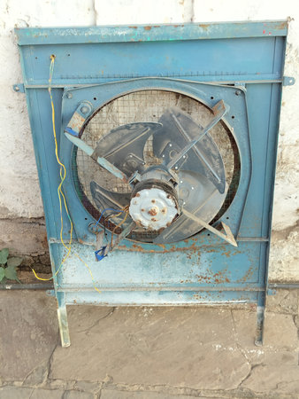 Old open air cooler selective object. Open Dial metal evaporative cooler motor with fanの写真素材
